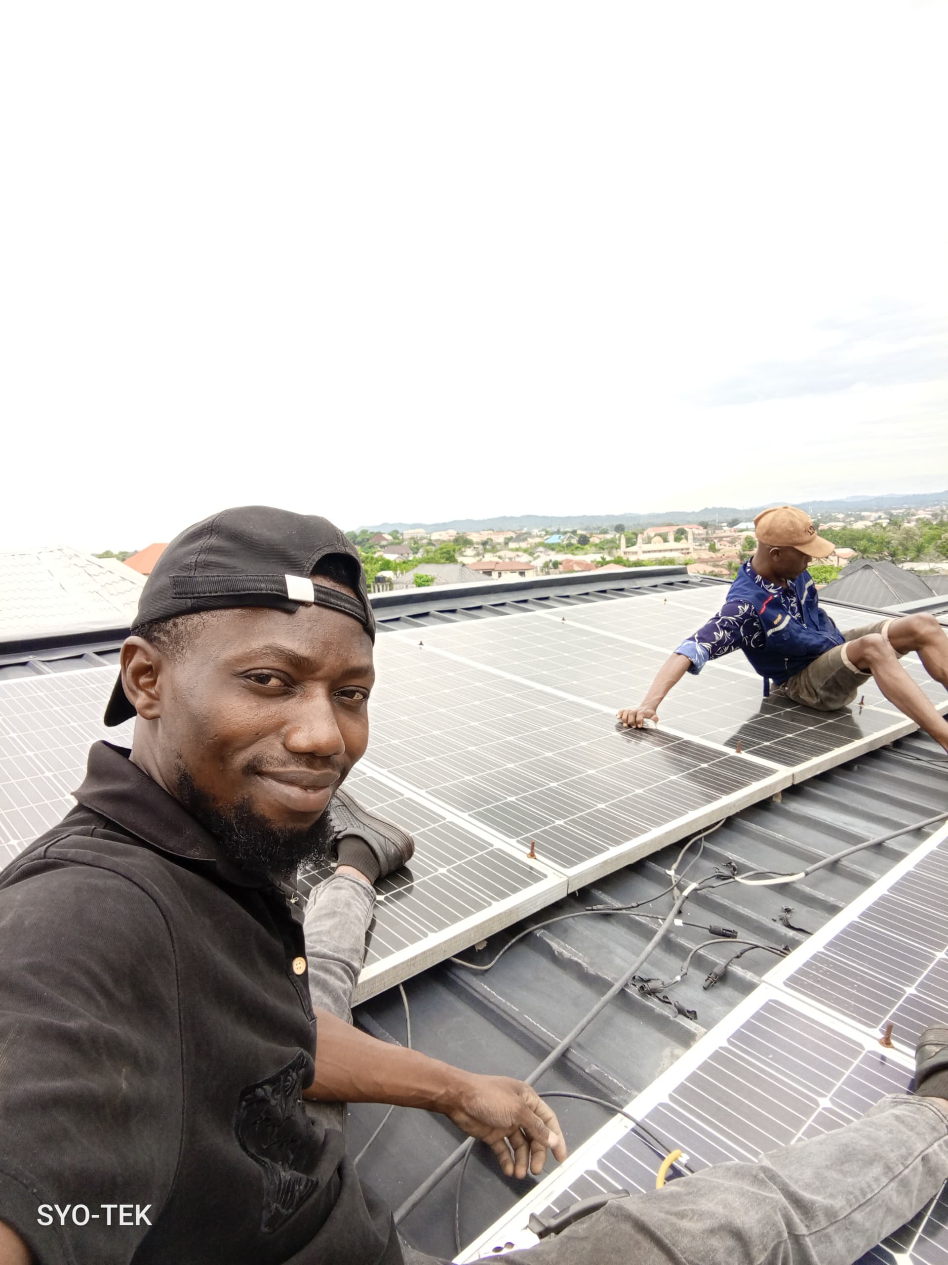 SYO TEK team mounting solar panels on a rooftop in Auchi